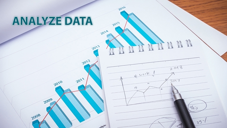Financial charts with pencil on table